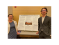Faculty mentor and student researcher standing with their poster
